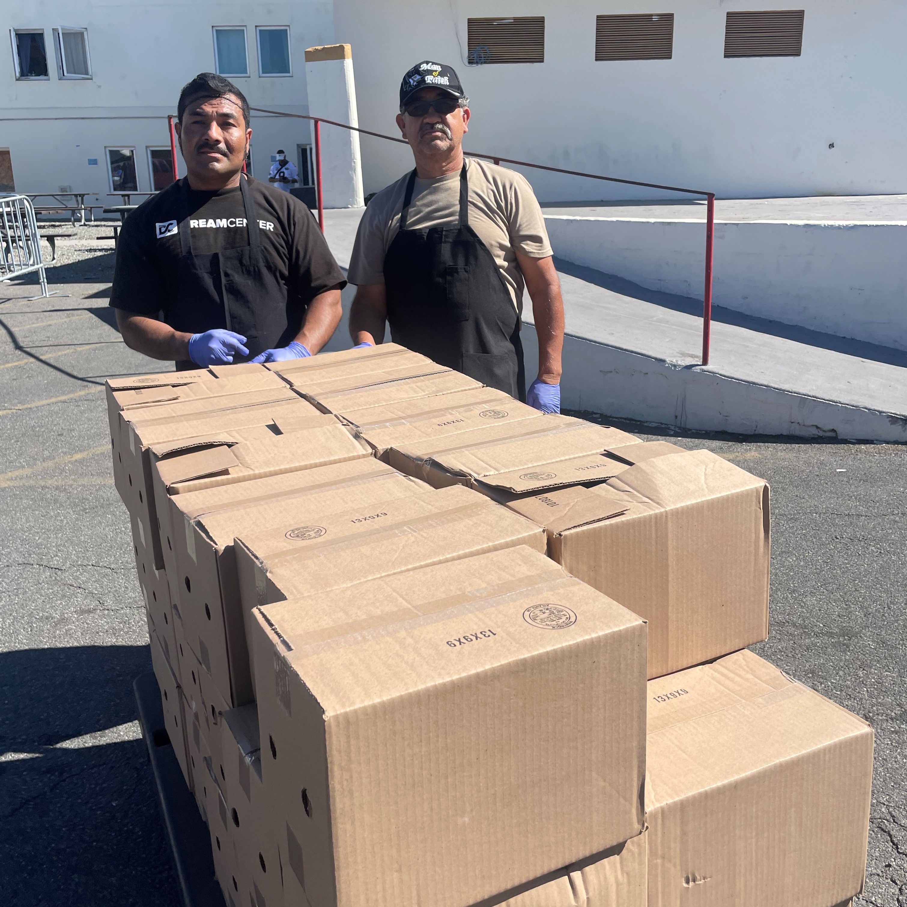 Dream Center staff with pallet of distribution cases