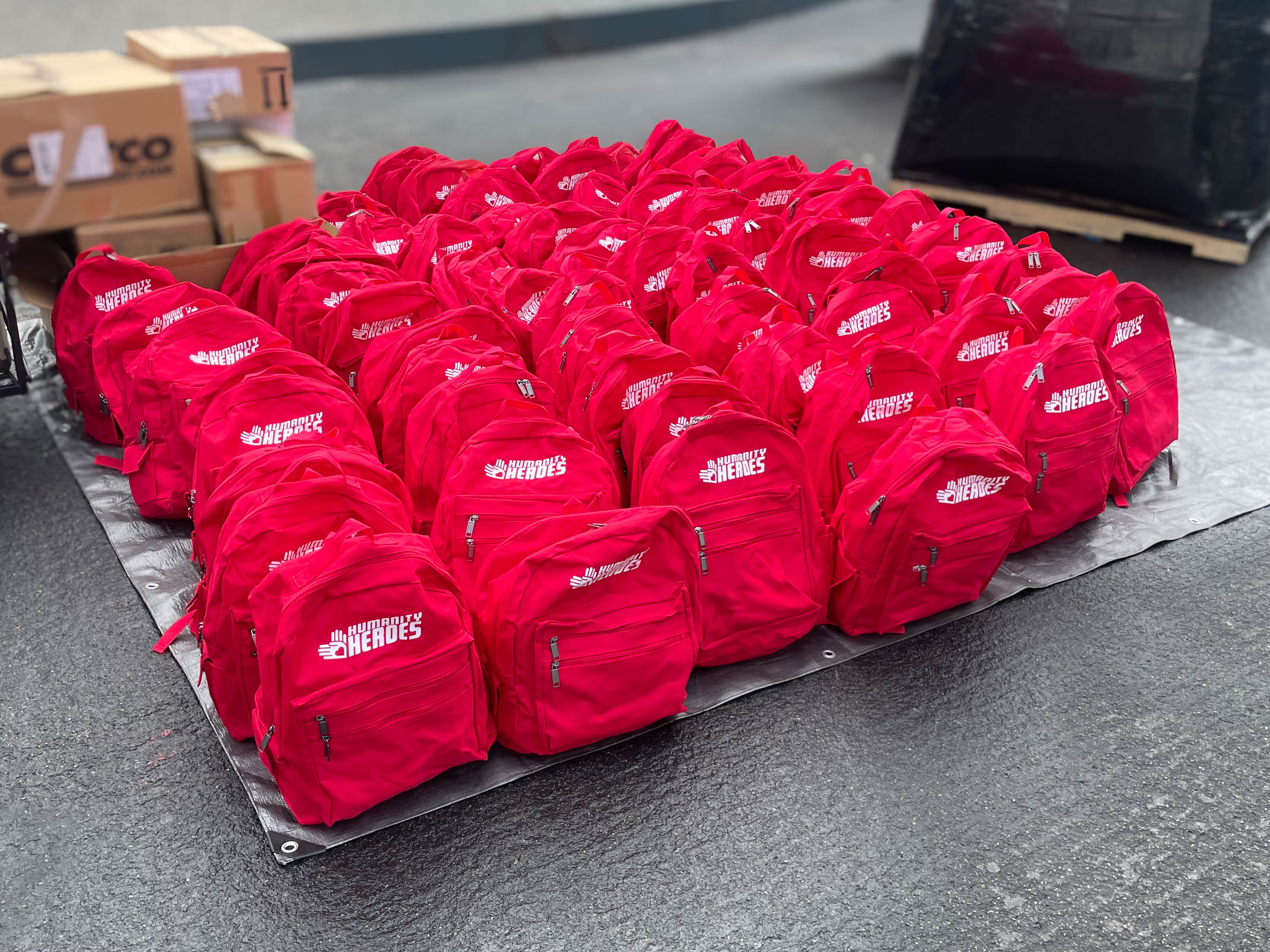 Backpacks filled with essentials ready for distribution